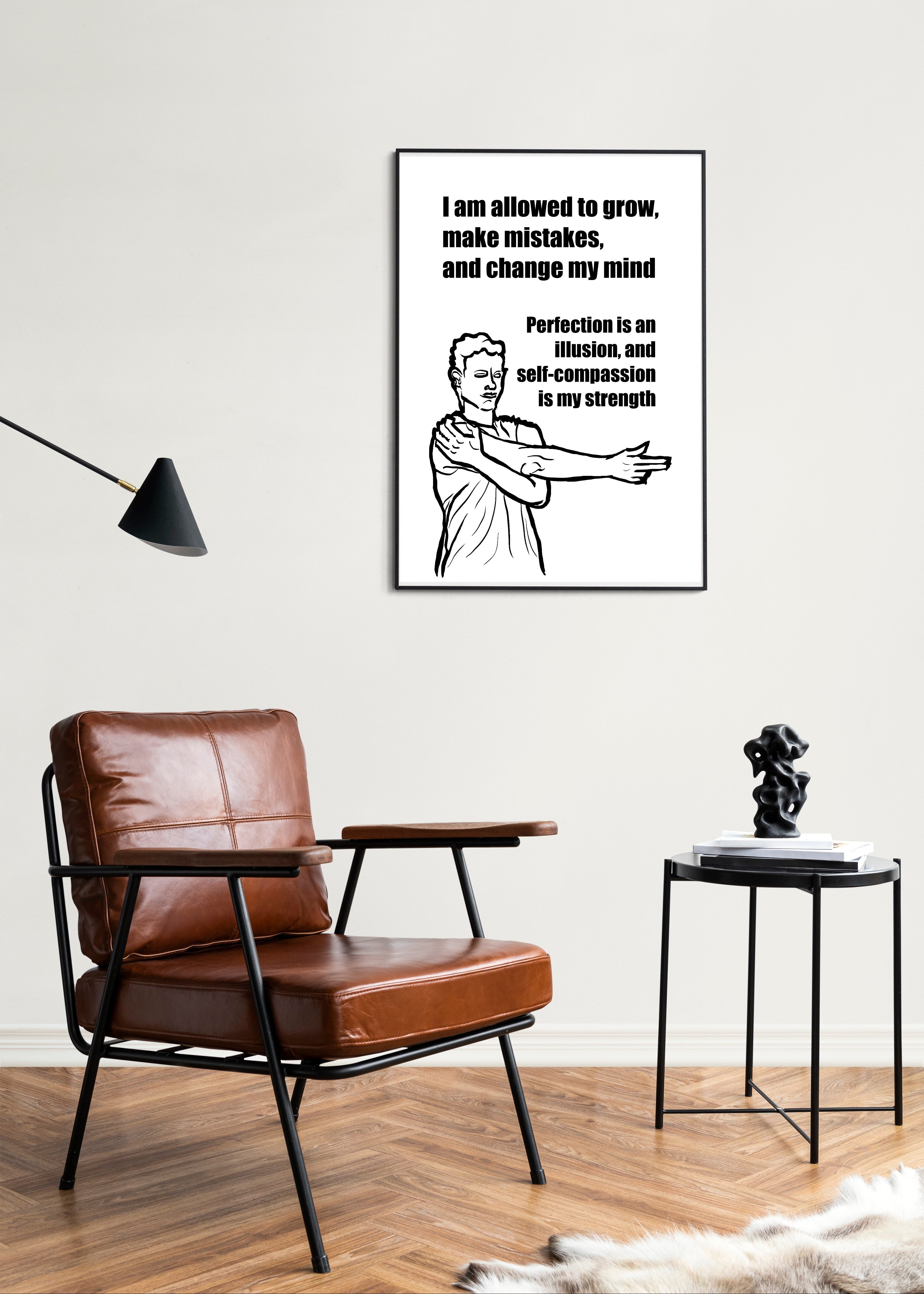 Living room with a brown leather chair, side table, and motivational poster on the wall.