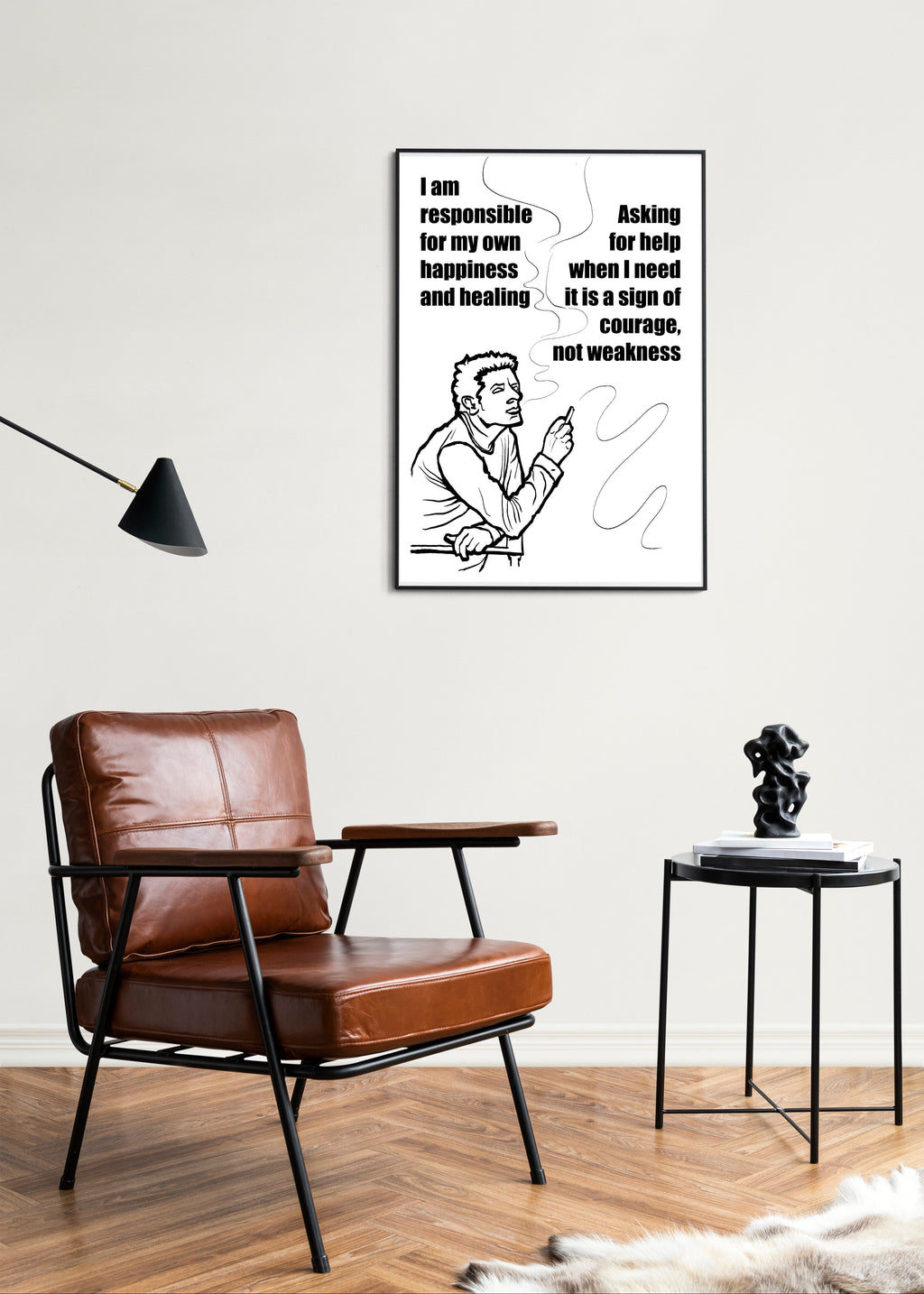 Modern interior with brown leather armchair, side table, and motivational poster on white wall.