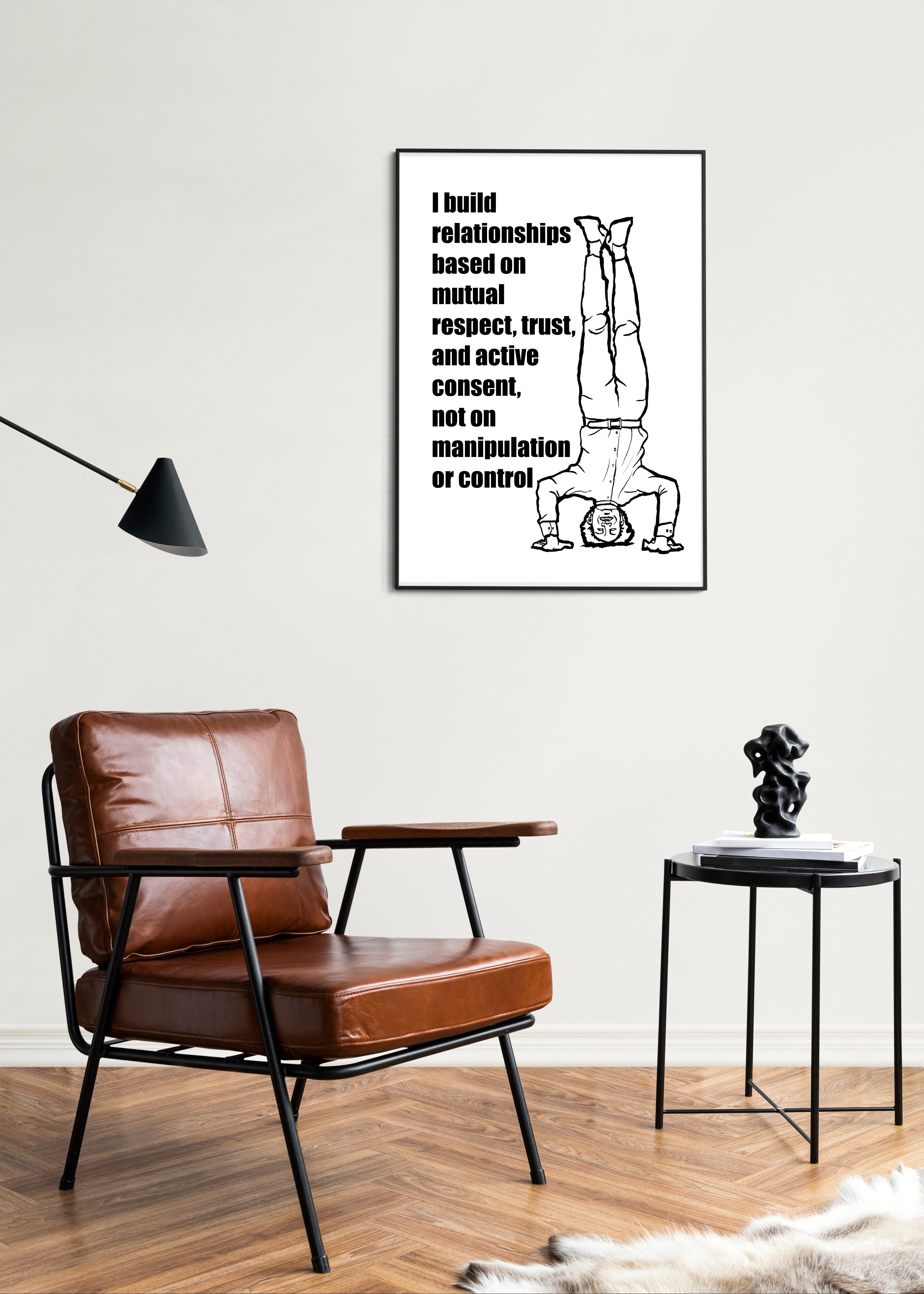 Living room with brown leather chair, black table, and framed poster on wall.