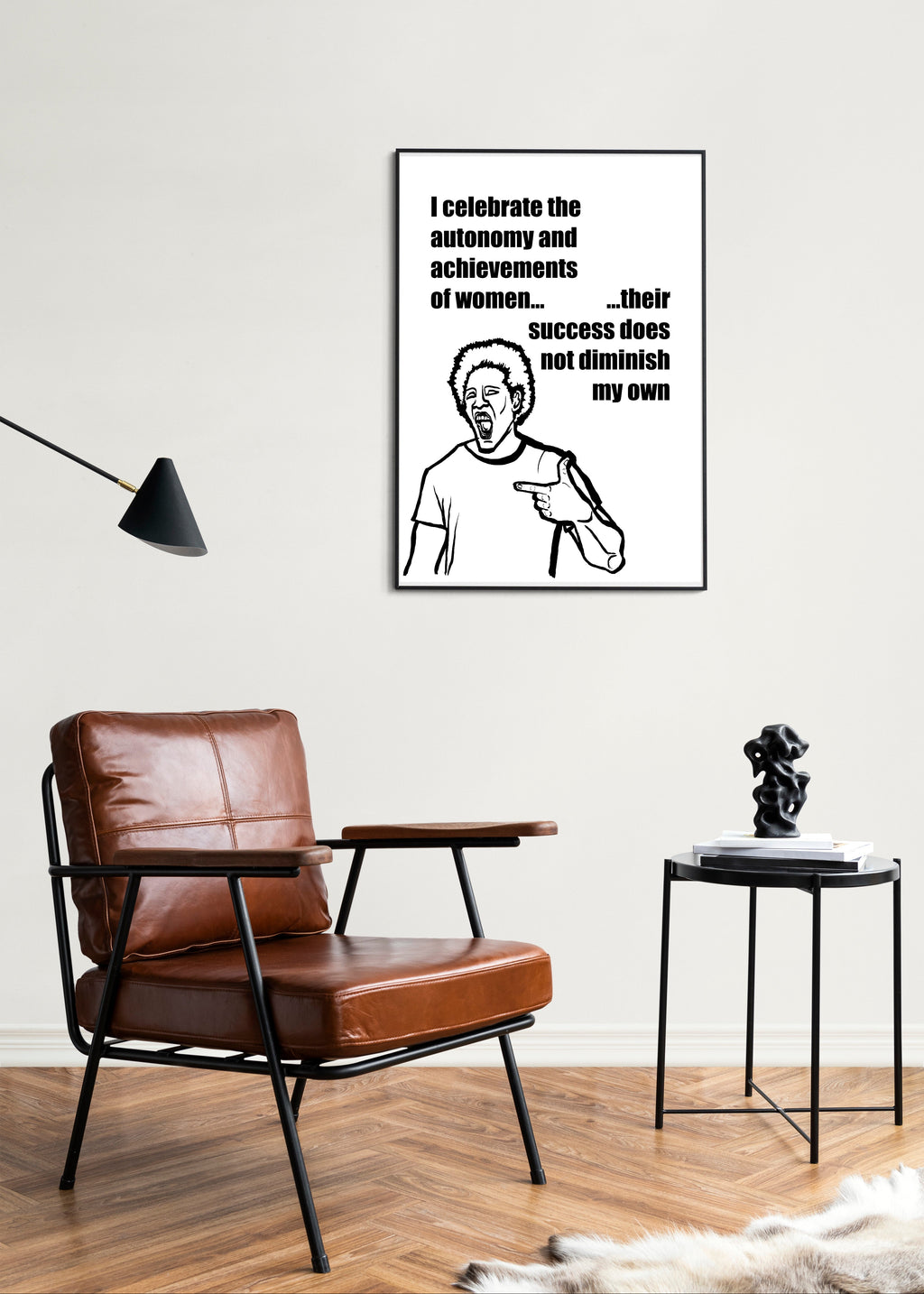 Living room with a brown leather chair, side table, and framed artwork on the wall.