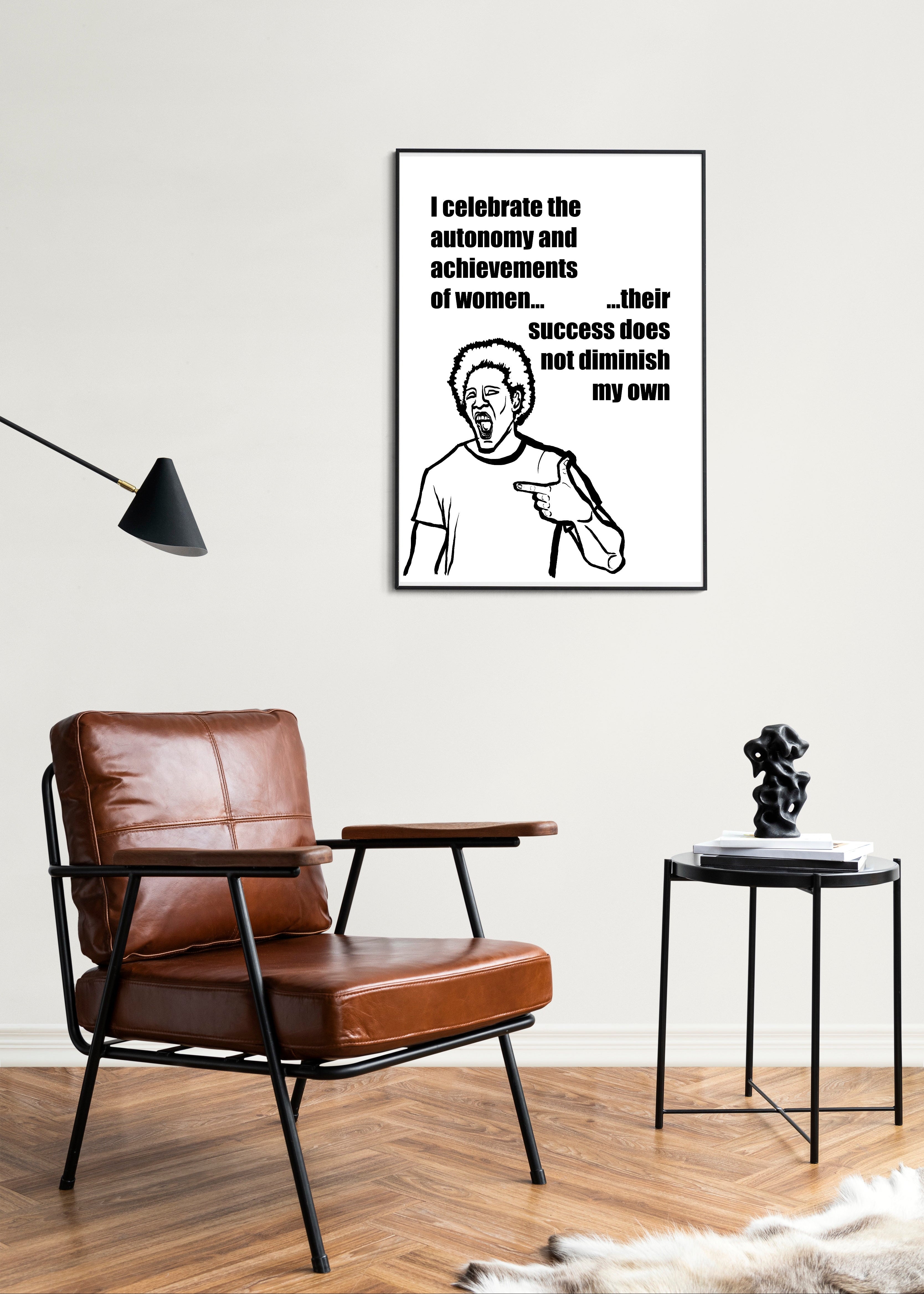 Living room with a brown leather chair, side table, and framed artwork on the wall.